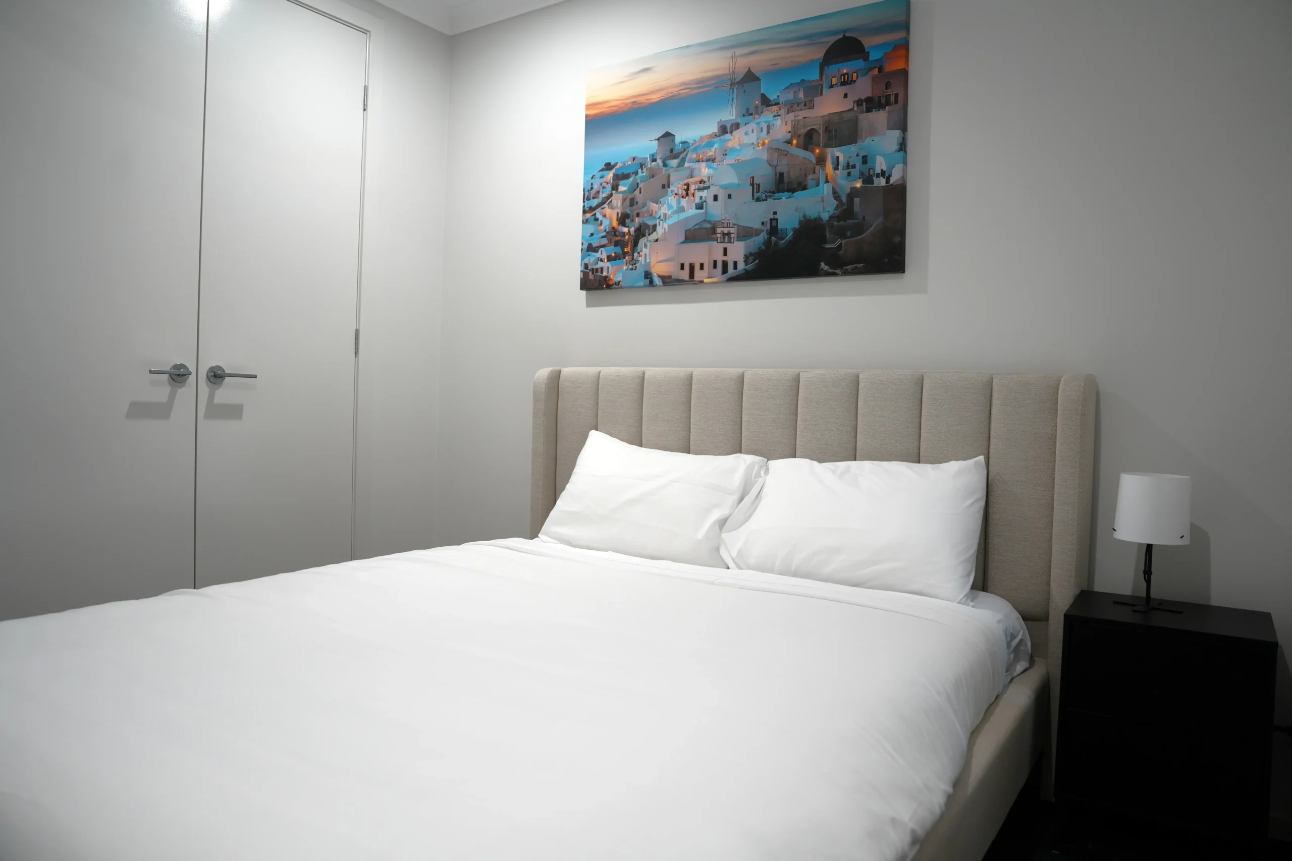 Greenbank Oasis fourth bedroom with queen bed, white coastal-style timber bedframe and dual windows