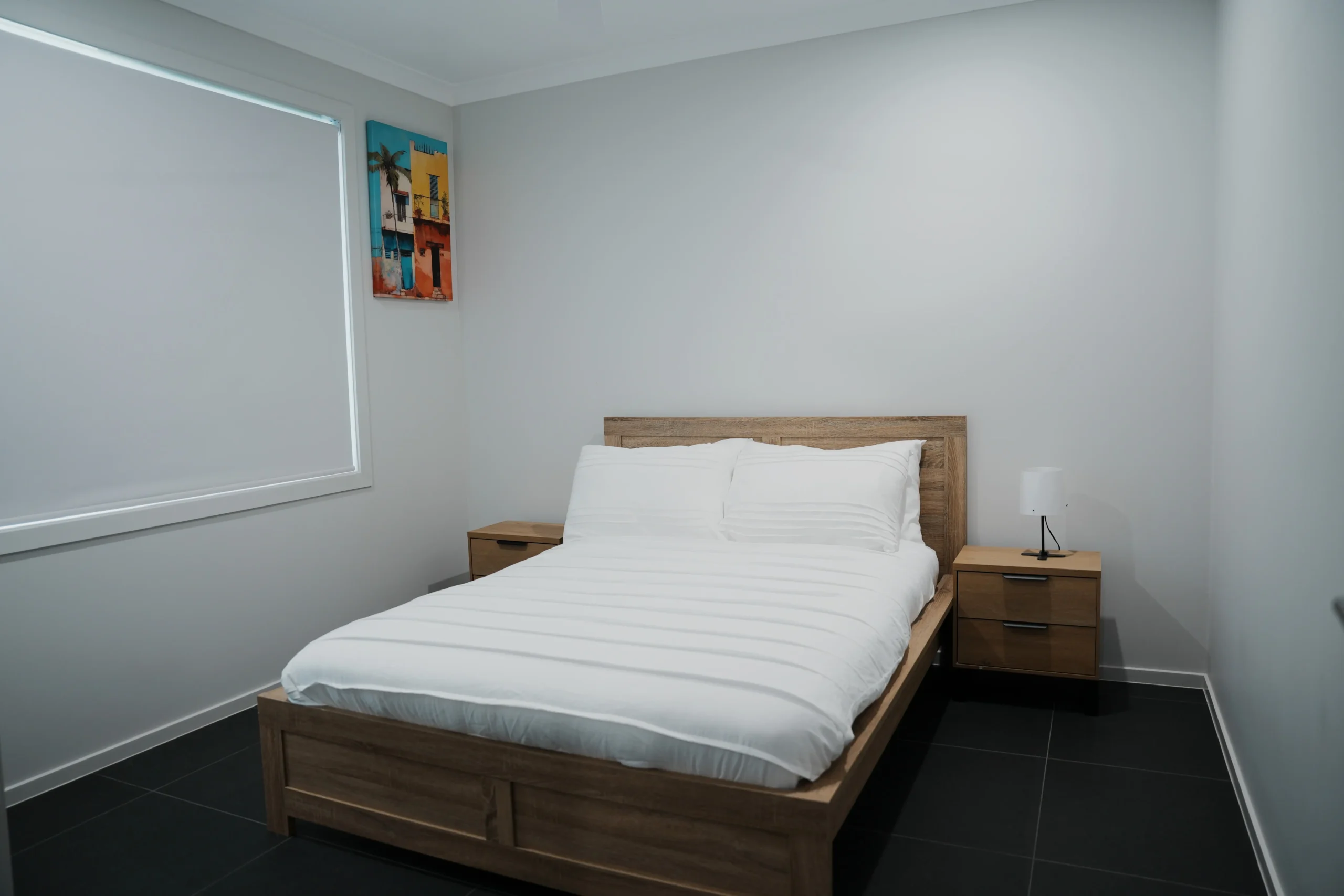 Greenbank Oasis third bedroom with queen bed, timber bedframe and matching bedside tables