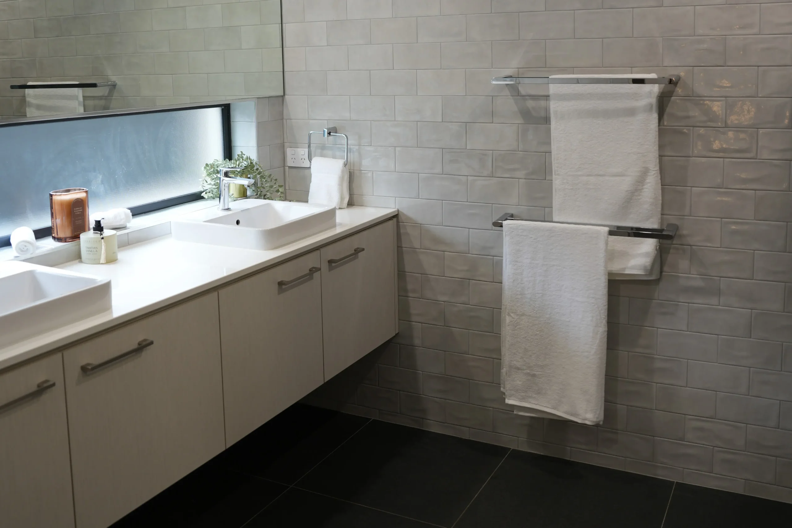 Greenbank Oasis master ensuite with double vanity, his-and-hers basins, double towel rails and full subway tile feature wall
