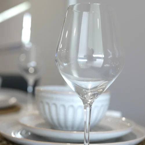 Place setting detail at Greenbank Oasis SafeStayz accommodation in Brisbane southside, with quality wine glass, ceramic dinnerware and woven placemat