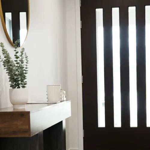 Front entry at Greenbank Oasis SafeStayz accommodation in Brisbane southside, with secure keyless entry door, key hooks, console table and styled welcome details